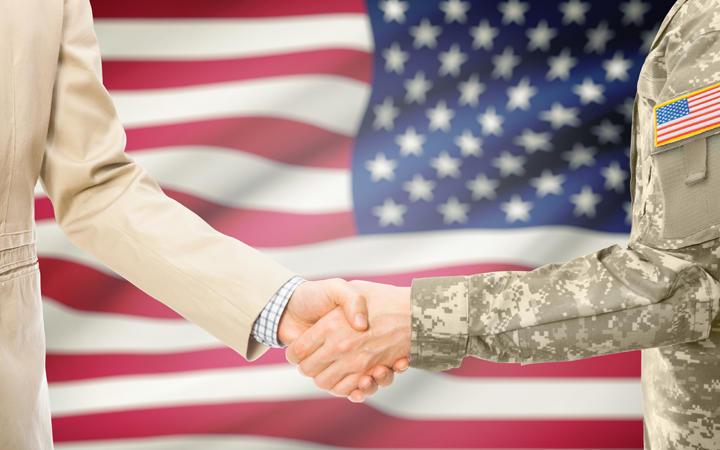 Miltary handshake over a flag